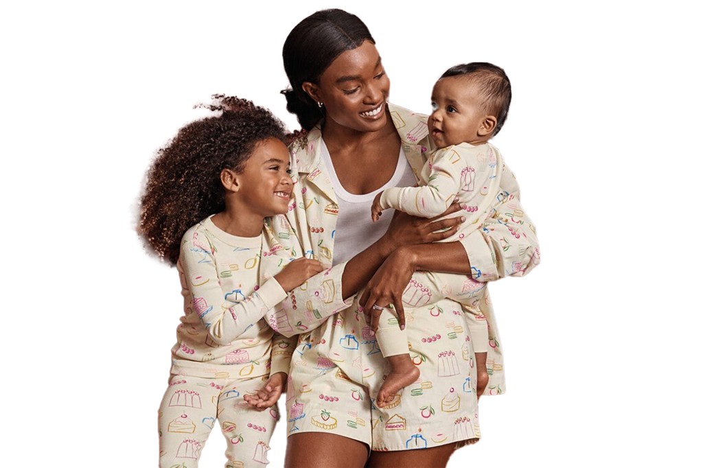 woman smiling while holding a baby