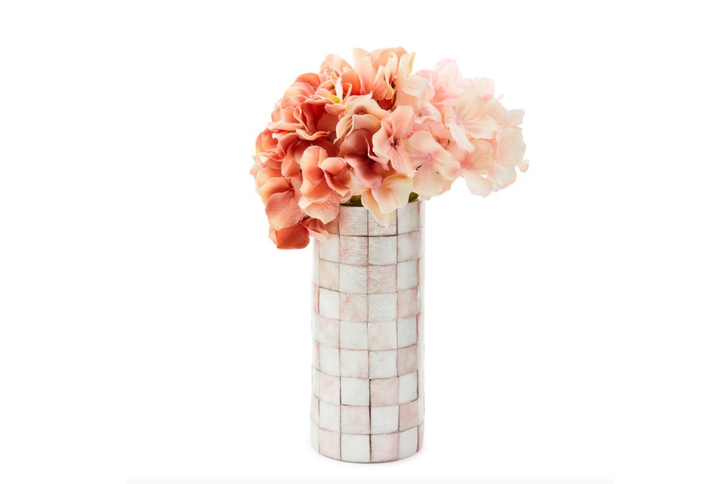 Pink and peach flowers in a tiled vase.