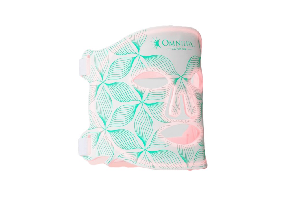 A face mask with green and pink design