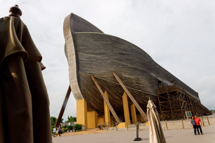 WILLIAMSTOWN, KENTUCKY, UNITED STATES - 2021/05/26: Visitors to Kenneth Ham's Ark Encounter pose for pictures in front of the Ark. Kenneth Ham's Ark Encounter is a theme park with a large ark mimicking the one described in the Biblical story of Noah. People visiting the theme park can participate in a number of different activities from walking through the ark's many informational exhibits, a walk through zoo and different rides.