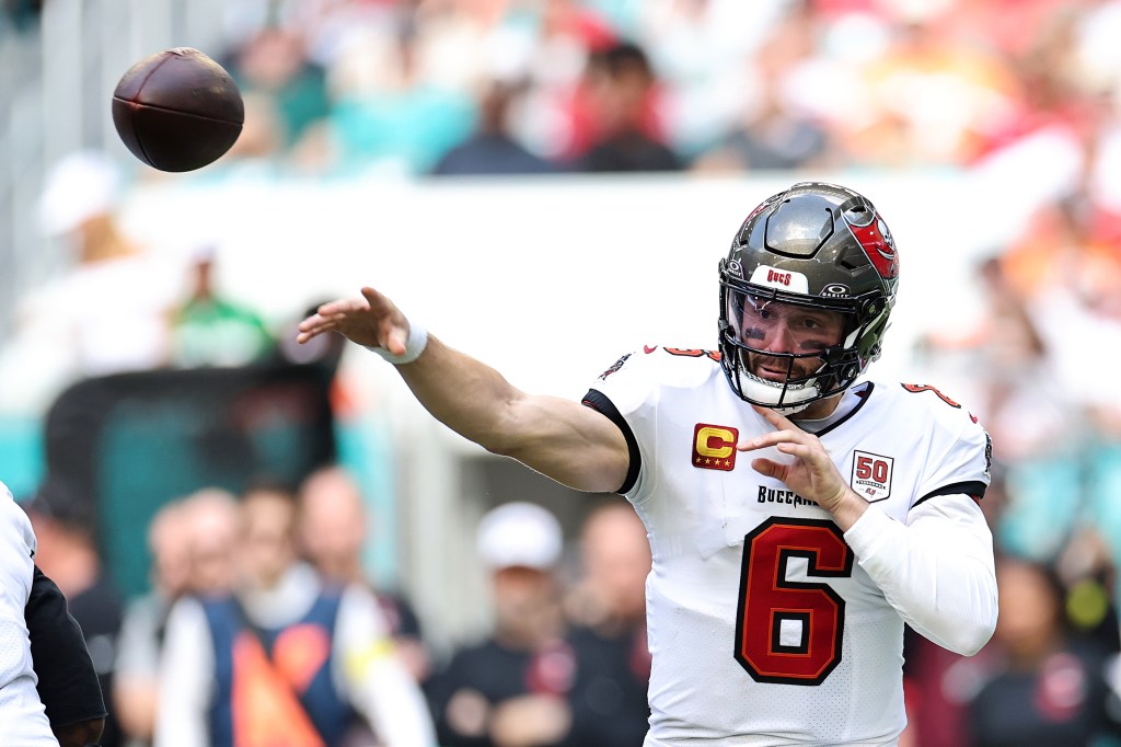 Tampa Bay Buccaneers player #6 mid-throw with a football.