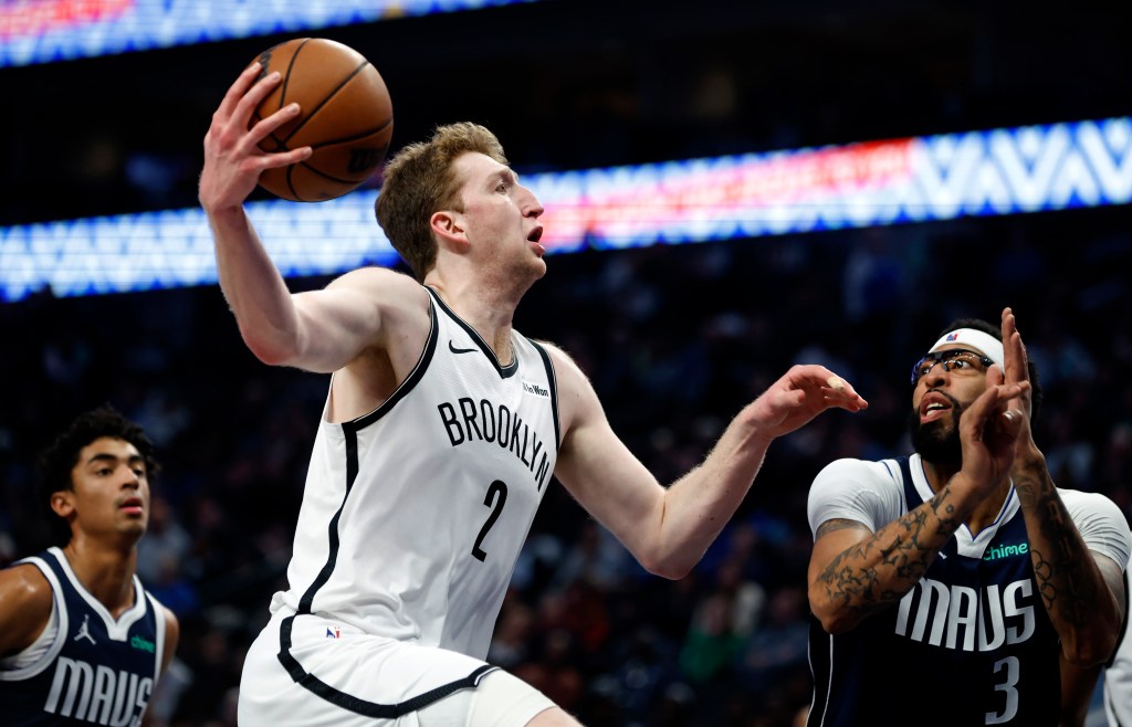 Danny Wolf #2 of the Brooklyn Nets goes to the basket as Anthony Davis #3 of the Dallas Mavericks defends in the first half at American Airlines Center on December 12, 2025 in Dallas, Texas.