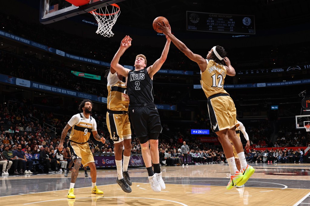 Tre Johnson (12) of the Washington Wizards blocks Danny Wolf's (2) shot.