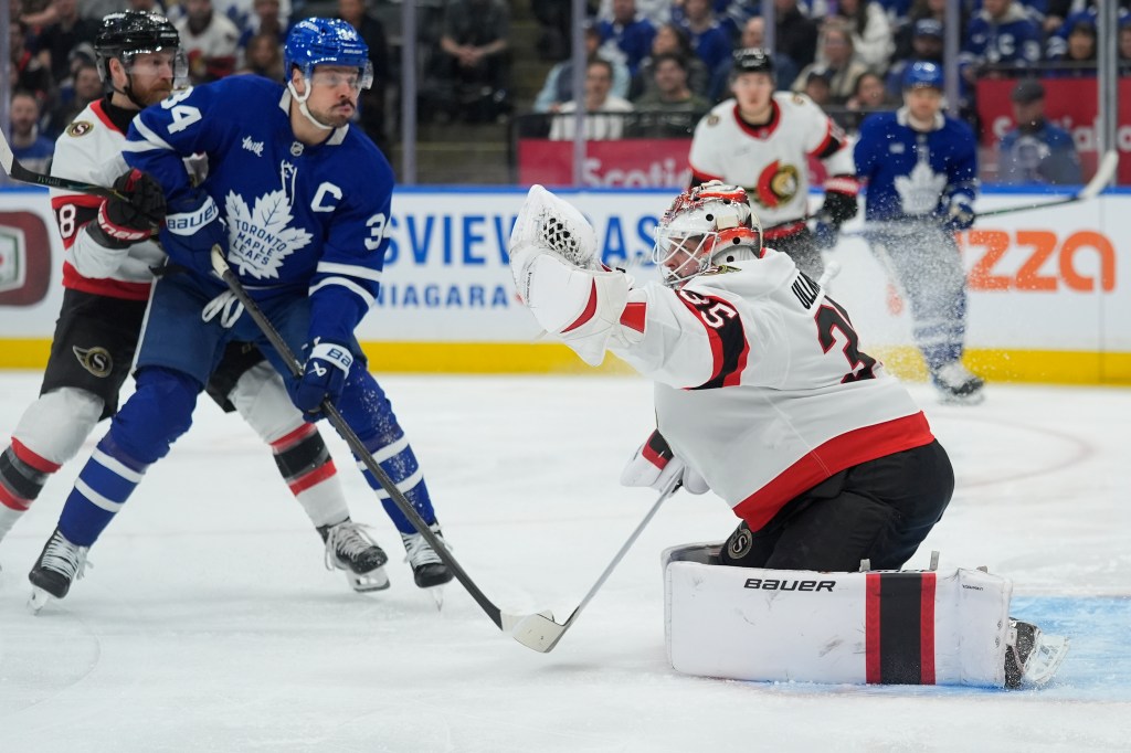 Linus Ullmark (35) makes a glove save as Toronto Maple Leafs forward Auston Matthews (34) closes in during the first period at Scotiabank Arena.