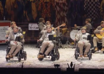 Spanish carnival group dress like Stephen Hawking, zip around in wheelchairs in bizarre performance to raise ALS awareness