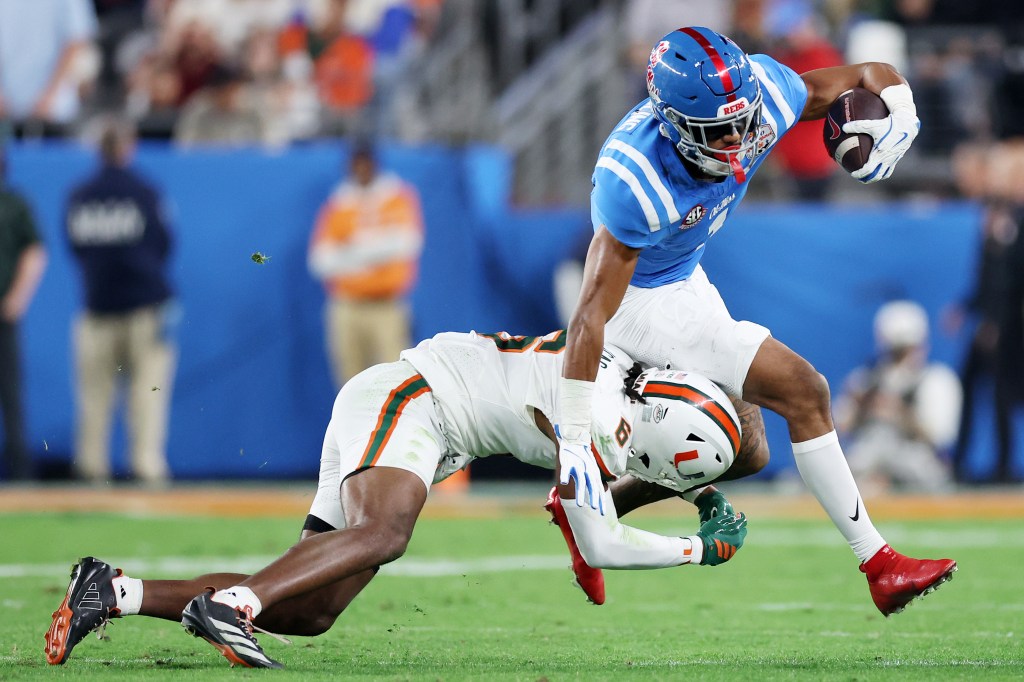 De'zhaun Stribling #1 of the Ole Miss Rebels carries the ball after a reception defended by Xavier Lucas #6 of the Miami Hurricanes in the third quarter during the 2025 College Football Playoff Semifinal at the VRBO Fiesta Bowl at State Farm Stadium on January 08, 2026.