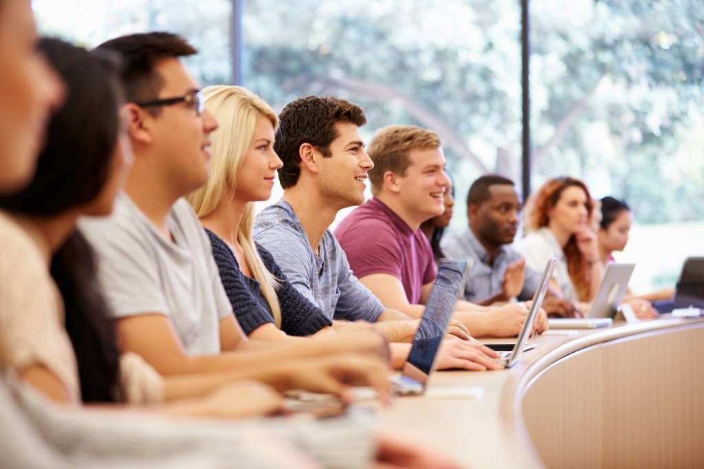 University students in a lecture using laptops.