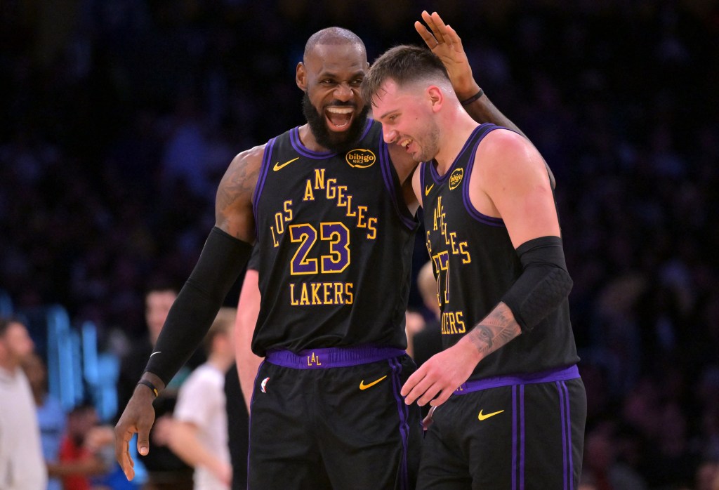 LeBron James and Luka Doncic, who combined for 65 points, celebrate during the Lakers' 128-121 win over the Grizzlies on Jan. 2, 2025 in Los Angeles.
