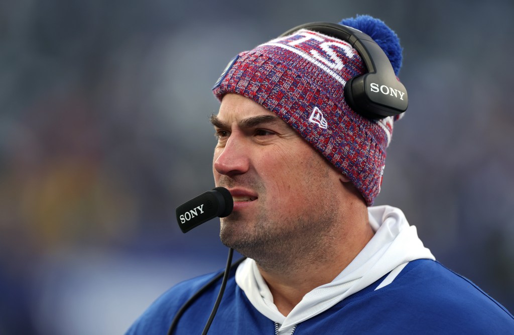 A man in a Dallas Cowboys beanie and Sony headset speaks into a microphone.