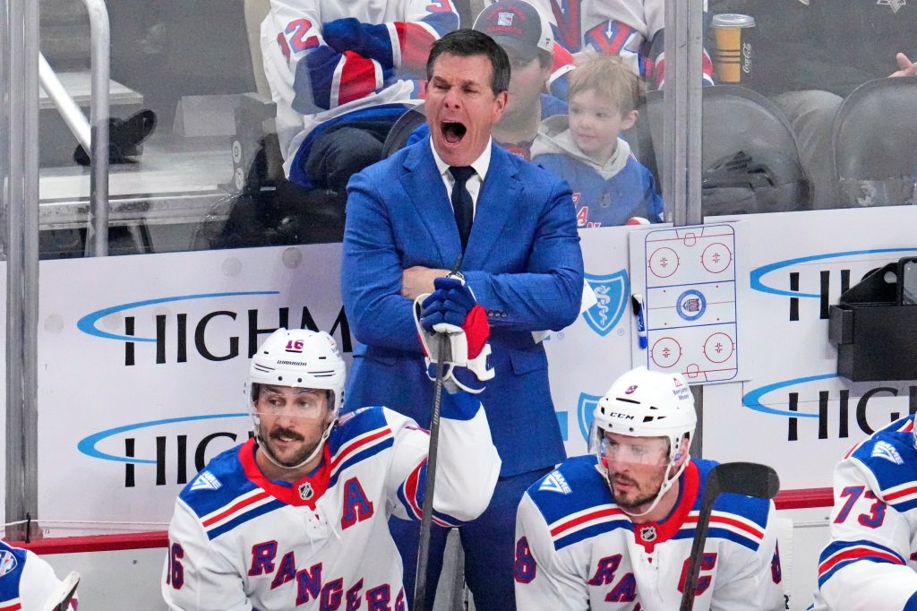 New York Rangers head coach Mike Sullivan yells instructions during a hockey game.