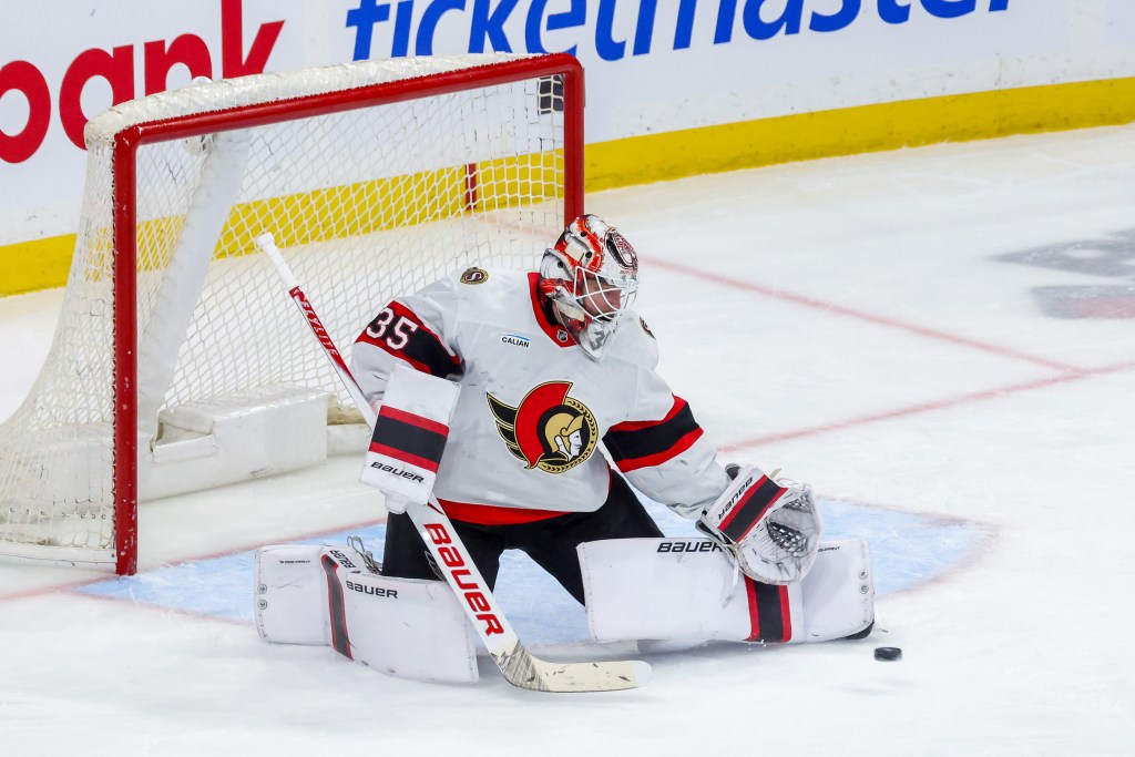 Goaltender Linus Ullmark #35 of the Ottawa Senators makes a pad save during third period action against the Winnipeg Jets at Canada Life Centre on December 15, 2025 in Winnipeg, Manitoba, Canada.