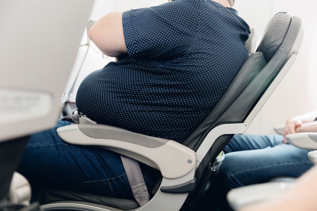 Overweight guy in an airplane seat.