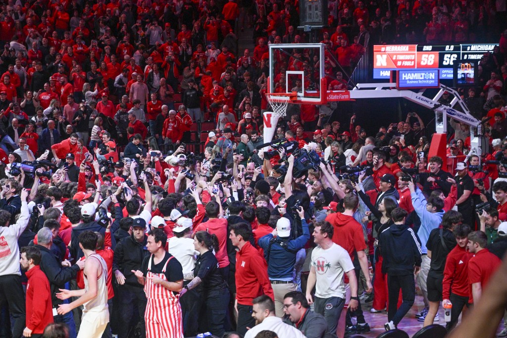 Nebraska fans storm the court after their 58-56 home win over No. 9 Michigan State on Jan. 2, 2025. 