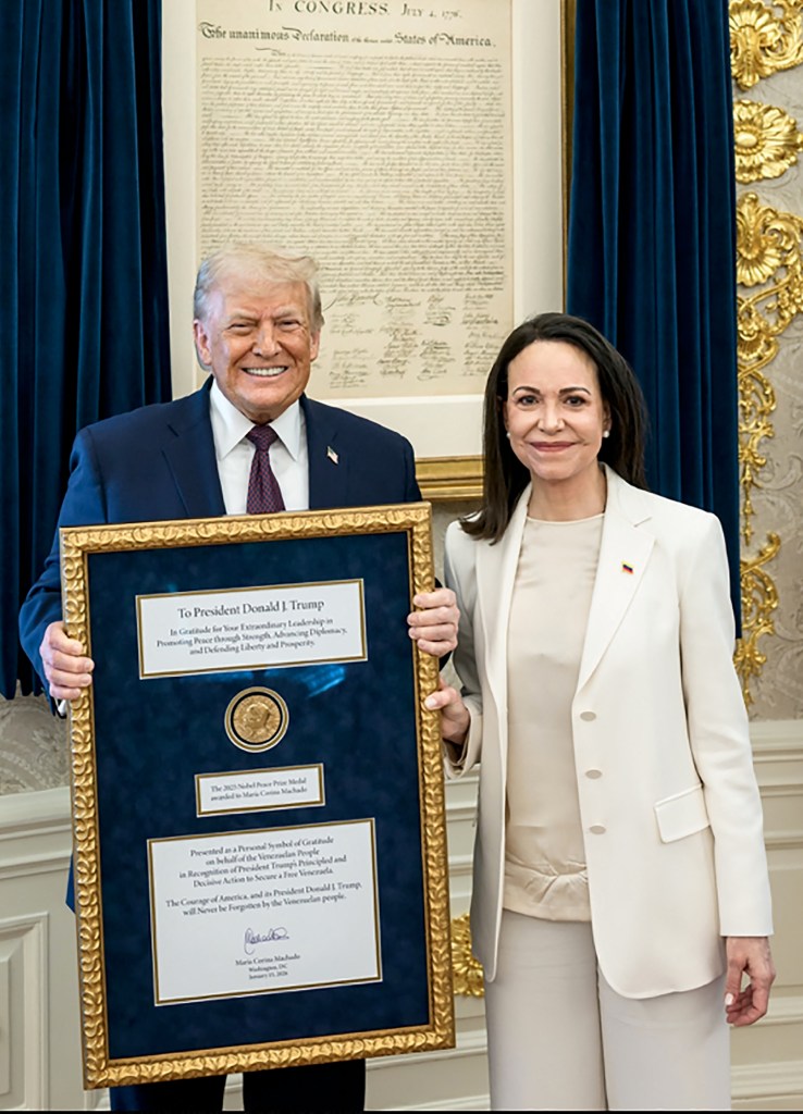Maria Corina Machado and Donald Trump hold a framed document with a Nobel Peace Prize medal.