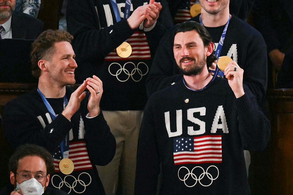 Goalie Connor Hellebuyck raises his gold medal as members of the US Men's Olympic hockey team are recogized by US President Donald Trump as he delivers the State of the Union address in the House Chamber of the US Capitol in Washington, DC, on February 24, 2026. 