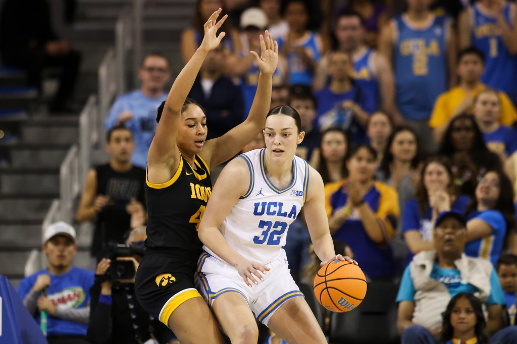 UCLA forward Angela Dugalic (32) dribbles against Iowa forward Hannah Stuelke.