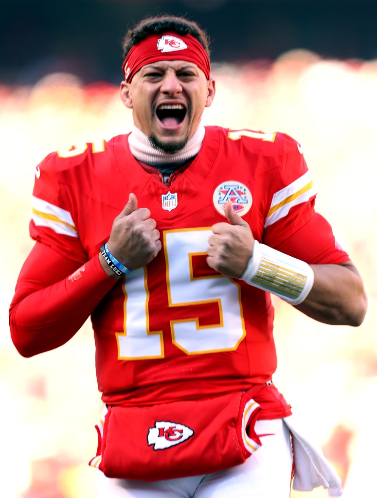 Patrick Mahomes in a red Kansas City Chiefs uniform with number 15, shouting and giving two thumbs up.