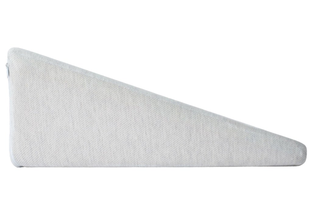 Wedge pillow with a white cover.