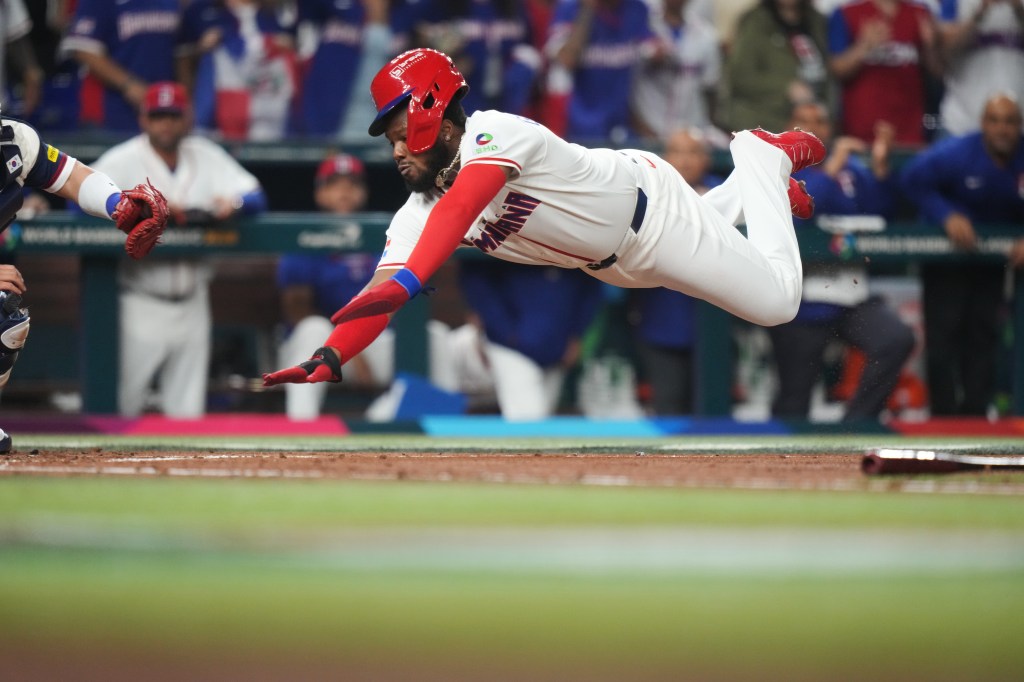 Dominican Republic's Vladimir Guerrero Jr. dives to score a run.