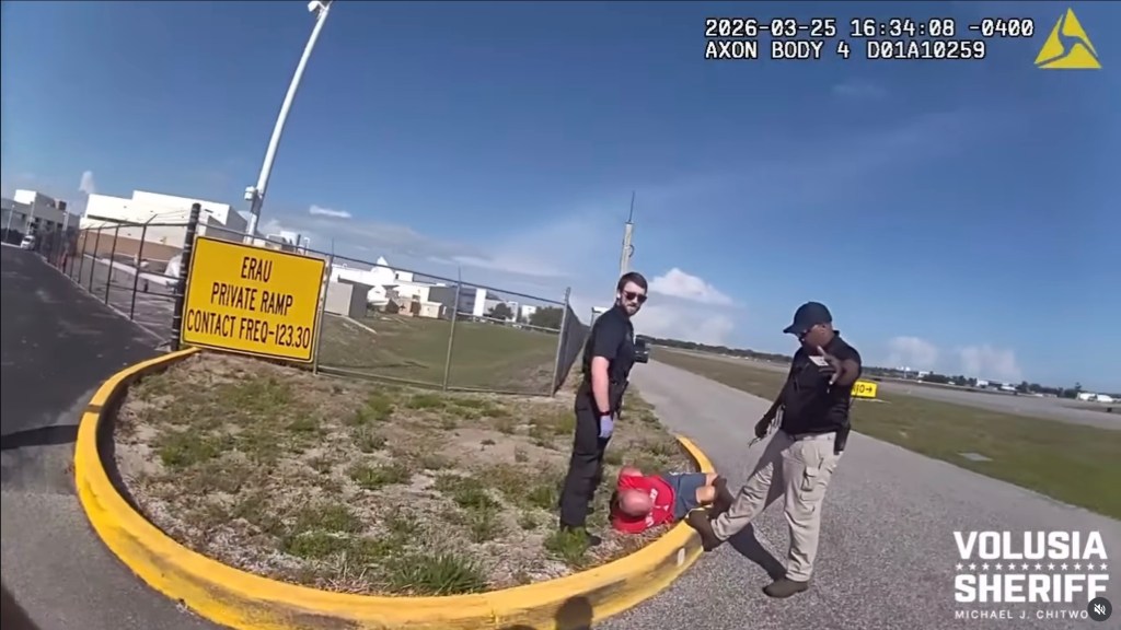 Bryan J. Parker of Holly Hill is seen lying on the ground by two deputies after being arrested on several charges, including aircraft piracy, burglary, indecent exposure, criminal mischief, and DUI.