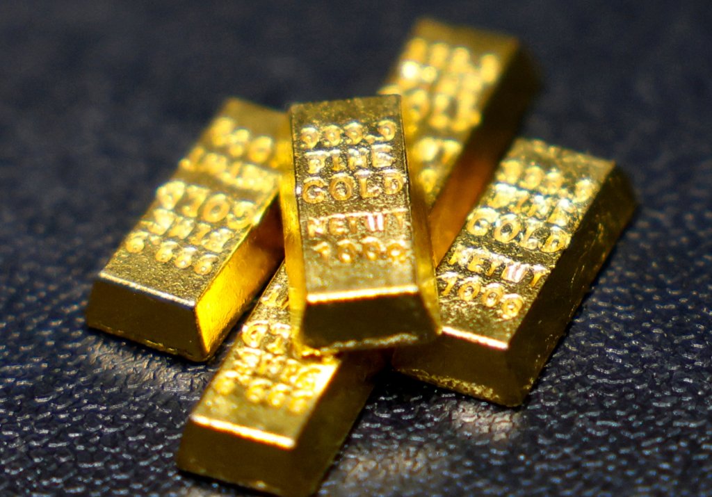 Replica gold bars on a dark surface.