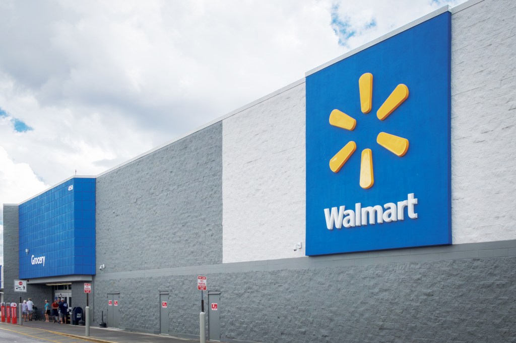 The exterior of a Walmart store in Venice, Florida, with a large blue sign featuring the Walmart logo and a separate blue section labeled "Grocery."