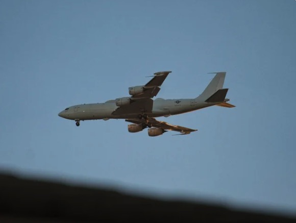 A Boeing E-6B Mercury "doomsday plane" in flight against a clear sky.