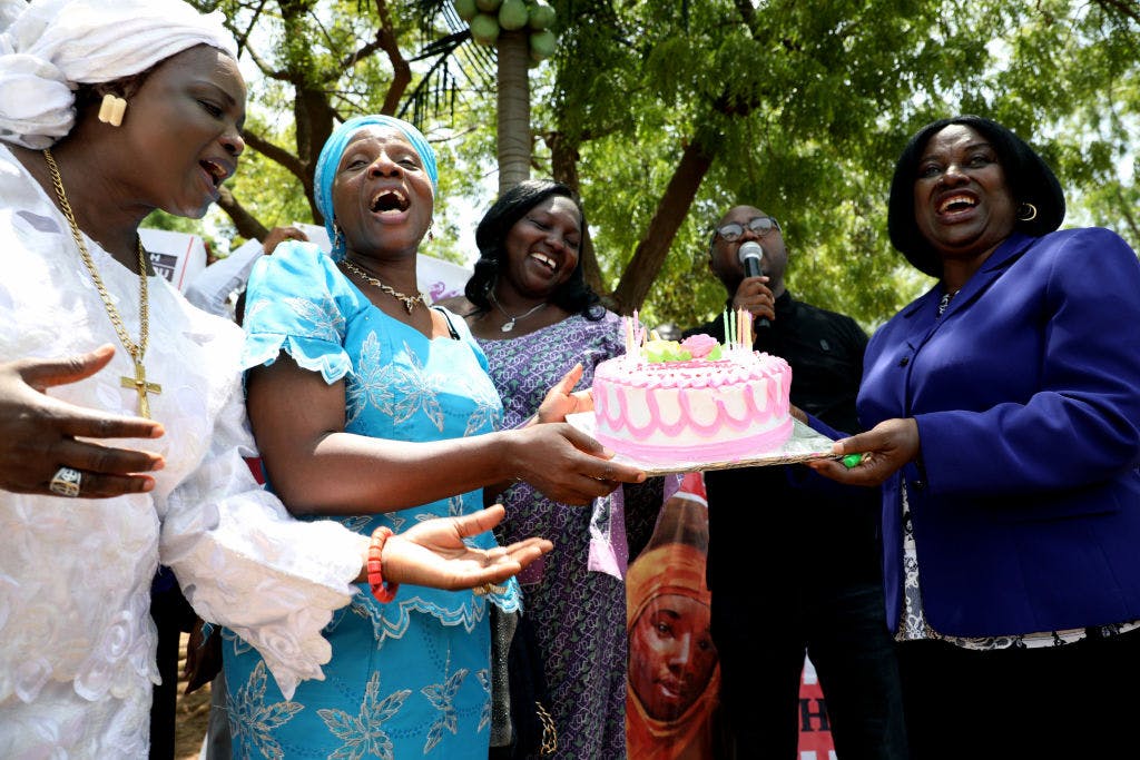 TOPSHOT - Relatives of schoolgirl, Leah Sharibu abducted by Boko Haram Islamists hold cake to mark her 16th birthday and two years in captivity at the Unity Fountain in Abuja, on May 14, 2019. - Leah Sharibu was among over 100 schoolgirls abducted from the Government Girls Secondary School in Dapchi, northeast Nigeria on February 19, 2018. But while schoolmates had been freed, she was held back for refusing to denounce her religion. (Photo by KOLA SULAIMON / AFP)