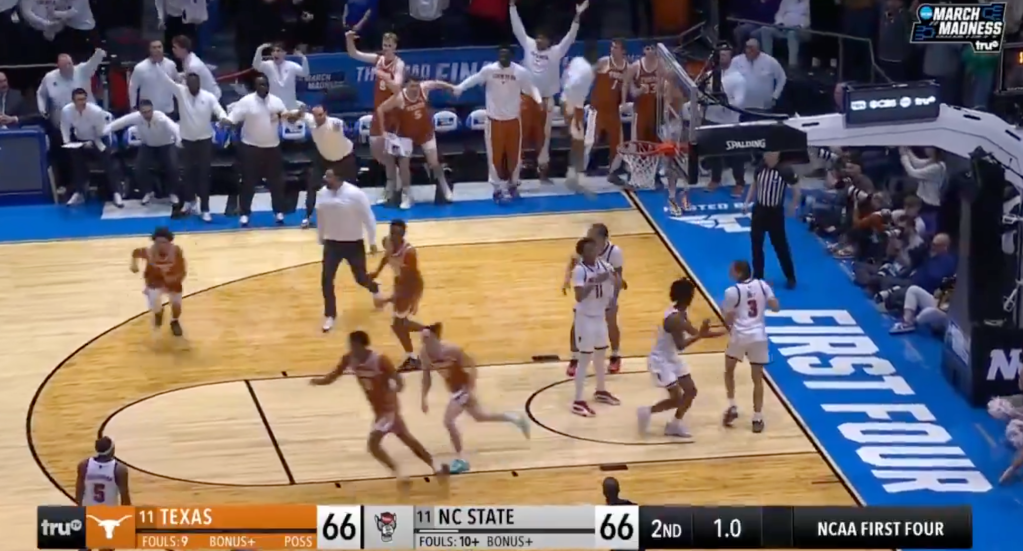 A basketball game with 1.0 seconds left on the clock and the score tied at 66 between Texas and NC State in the NCAA First Four.