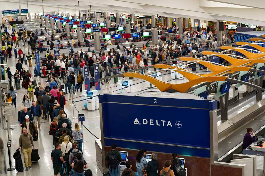 Travelers navigating through Atlanta Hartsfield-Jackson International Airport.