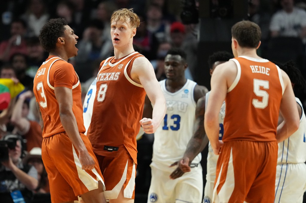 Dailyn Swain, Matas Vokietaitis, and another Texas Longhorns player celebrating during a basketball game against the BYU Cougars.