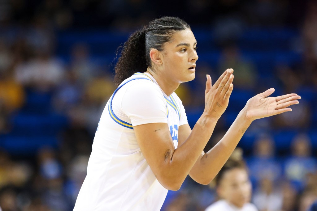 Lauren Betts clapping during a basketball game.