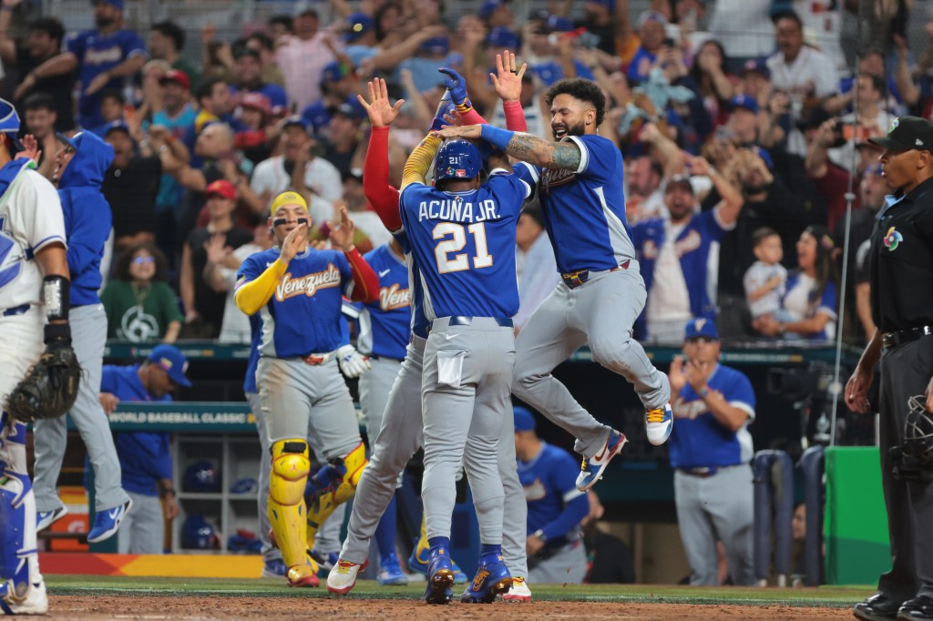 Ronald Acuña Jr. (21) and Gleyber Torres (25) react after Acuña scores in a World Baseball Classic semifinal game.