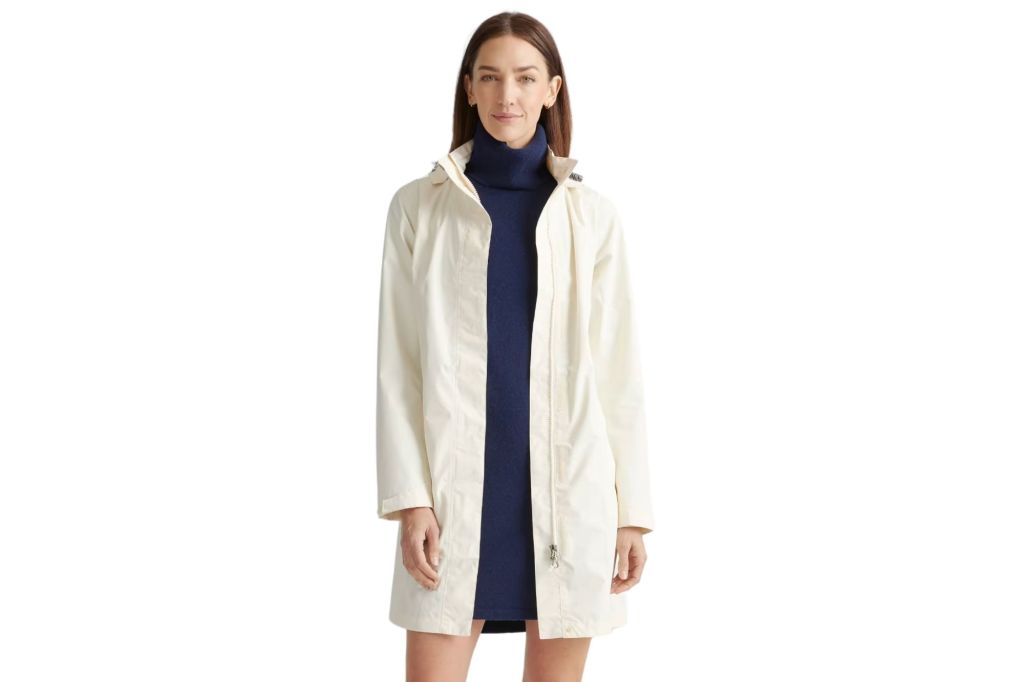 A woman in a dress and a rain jacket.