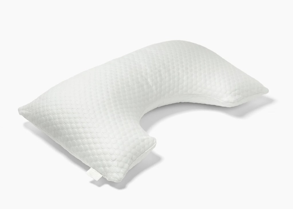 White pillow with a unique, ergonomic shape and honeycomb-like texture.