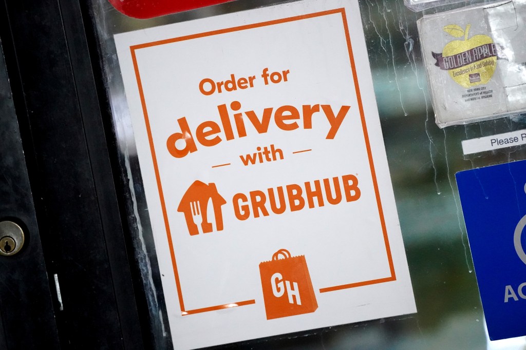 A white sign with orange text and logos reads "Order for delivery with GRUBHUB."