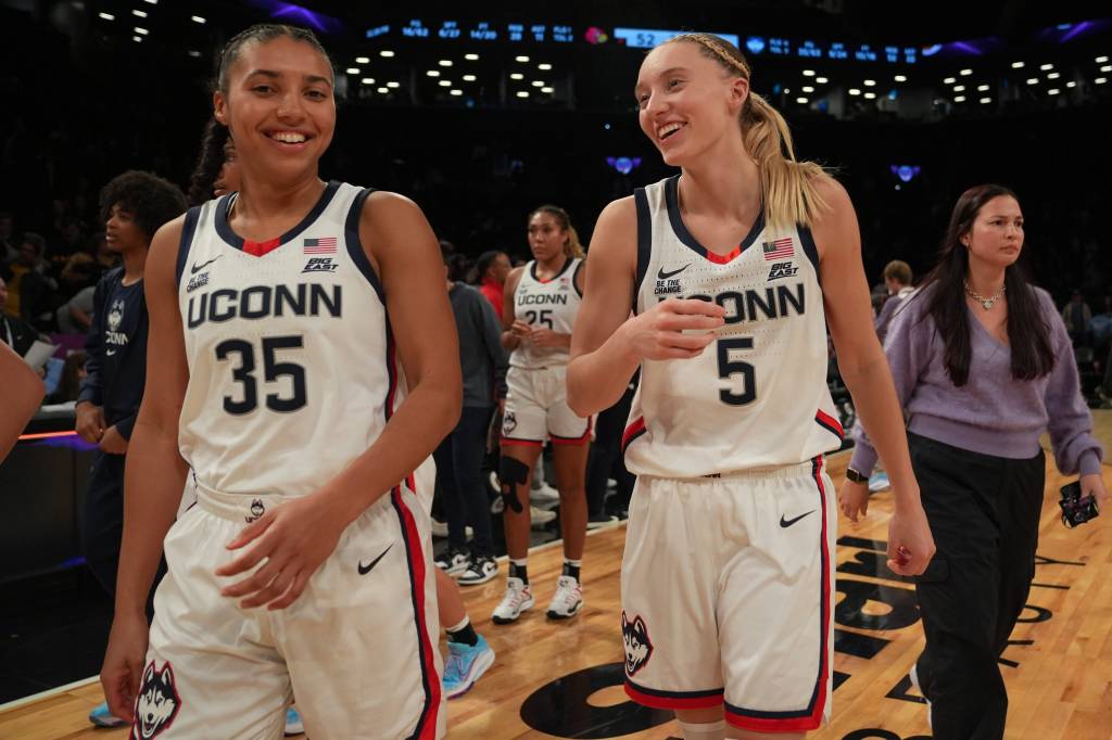 Connecticut Huskies guard Azzi Fudd (35) and Connecticut Huskies guard Paige Bueckers (5) celebrate after the game against the Louisville Cardinals on Dec. 7, 2024.