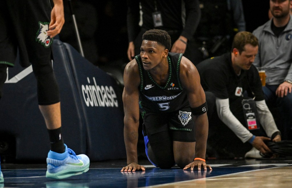 Timberwolves guard Anthony Edwards crawls in pain after suffering a knee injury during Game 4 against the Nuggets on April 25, 2026.