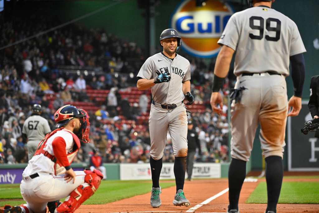 New York Yankees designated hitter Giancarlo Stanton (27) reacts as he scores a run at Fenway Park.