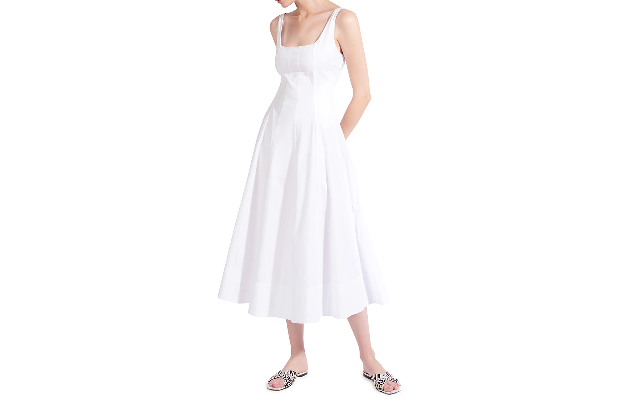Model wearing a white Staud Wells midi dress.