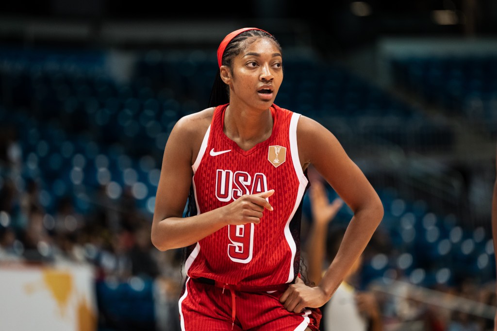 Basketball player Angel Reese of USA in a red jersey with number 9 and the text "USA" looks on during a game.