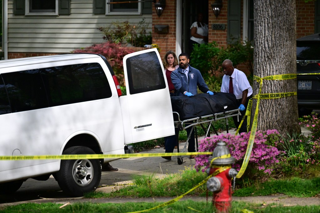 Medical examiner's office staff remove a body from a home after an apparent murder-suicide.