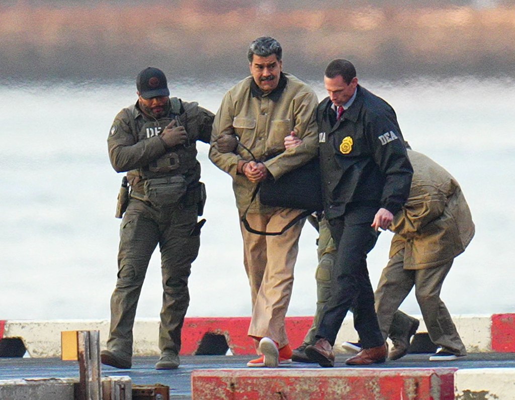 NEW YORK, NY - JANUARY 5: Nicolas Maduro and his wife, Cilia Flores, are seen in handcuffs after landing at a Manhattan helipad, escorted by heavily armed Federal agents as they make their way into an armored car en route to a Federal courthouse in Manhattan on January 5, 2026 in New York City.  (Photo by XNY/Star Max/GC Images)

