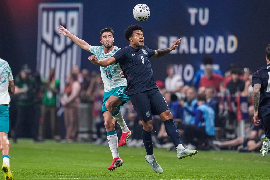 US midfielder Weston McKennie (8) heads the ball in front of Portugal defender Goncalo Inacio (14).