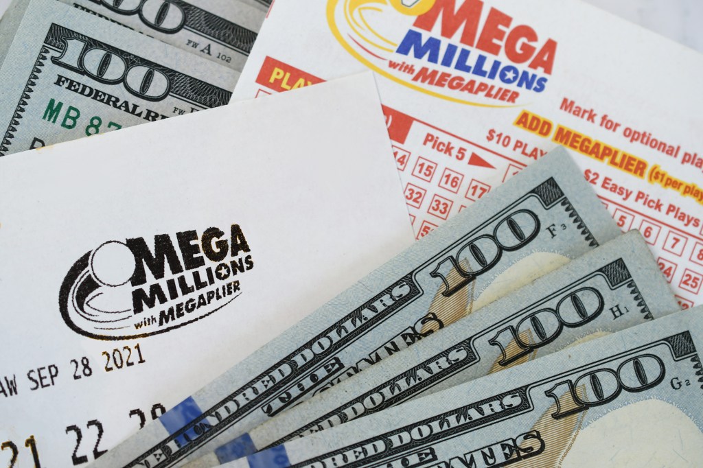 Mega Millions lottery tickets and hundred dollar bills.