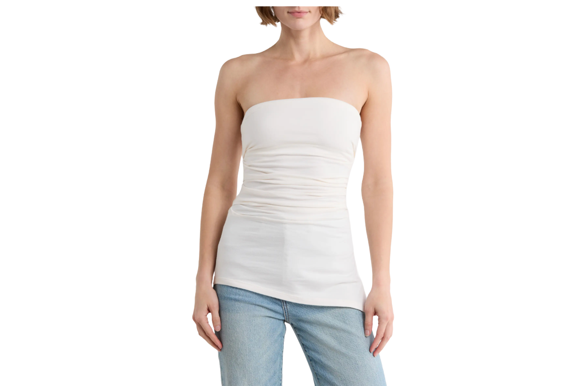 A person wearing a strapless white top and light blue jeans.