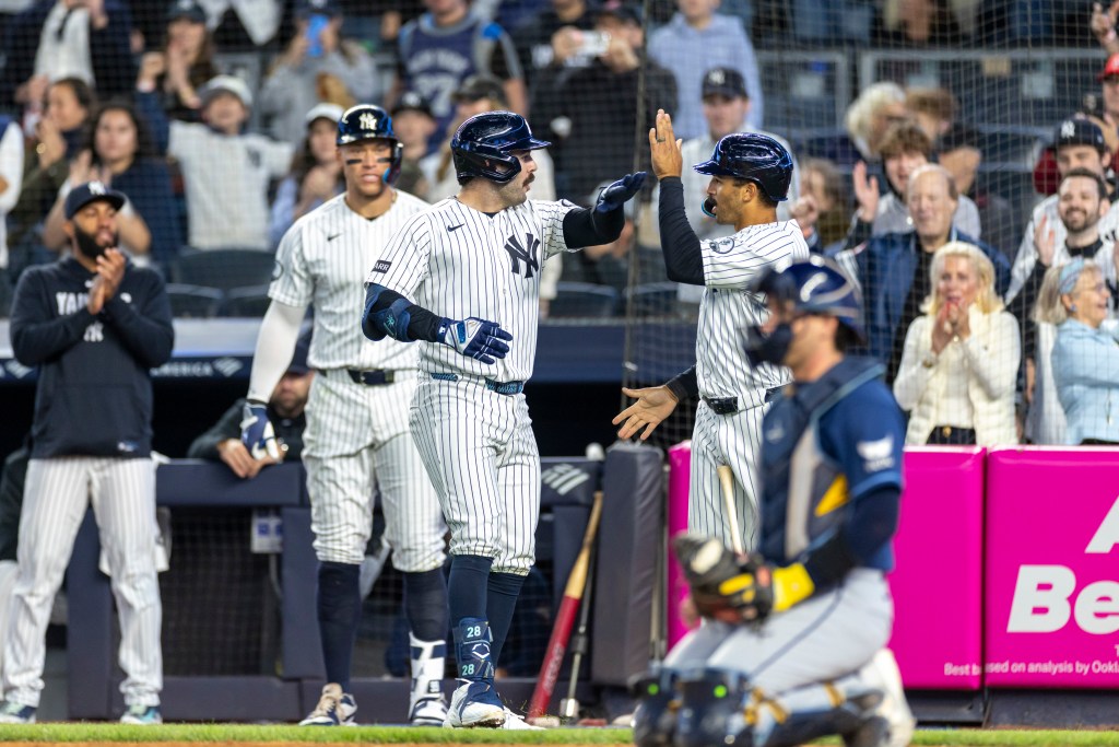 Yankees catcher Austin Wells (28) is greeted by New York Yankees center fielder Trent Grisham (12) after he scores on his solo home run in the fifth inning against the Tampa Bay Rays at Yankee Stadium, Friday, May 22, 2026, in Bronx, NY. 