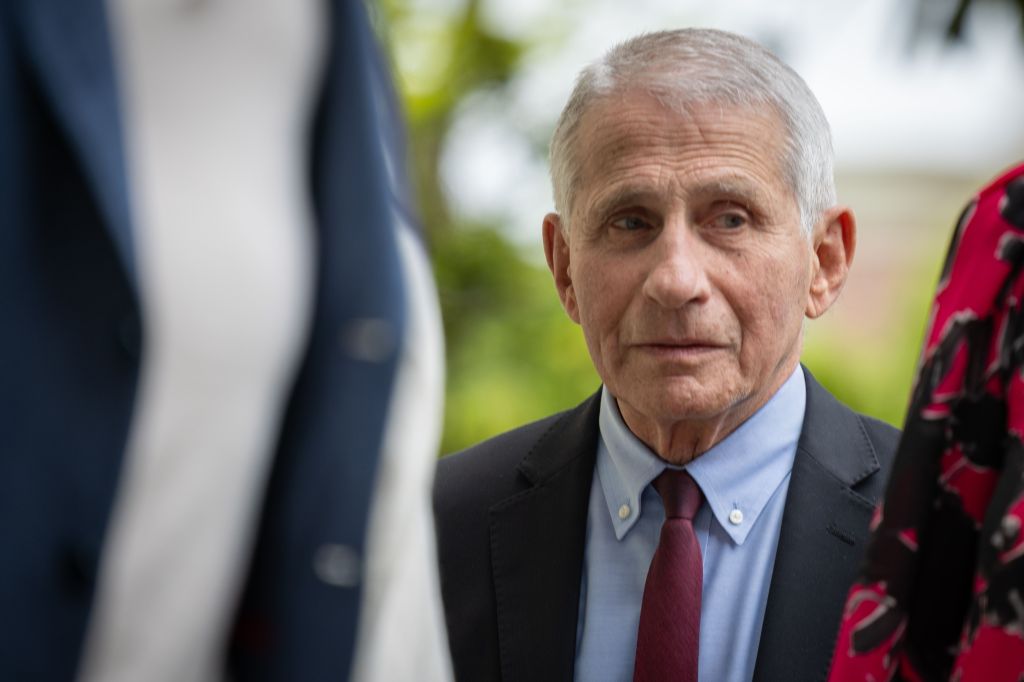 Dr. Anthony Fauci in a suit and tie looks to his right at the 33rd Annual White House Correspondents' Garden Brunch.