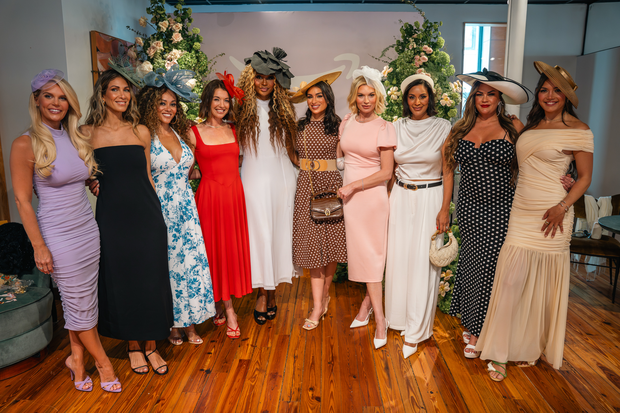 Nine women, including reality TV moms, pose at Amazon's Mother's Day-themed Kentucky Derby trip.