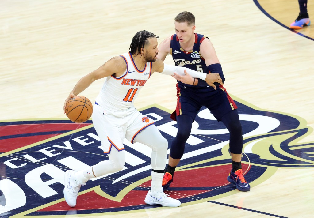 New York Knicks guard Jalen Brunson (11) drives down court as Cleveland Cavaliers guard Sam Merrill (5) gives chase during the second quarter.